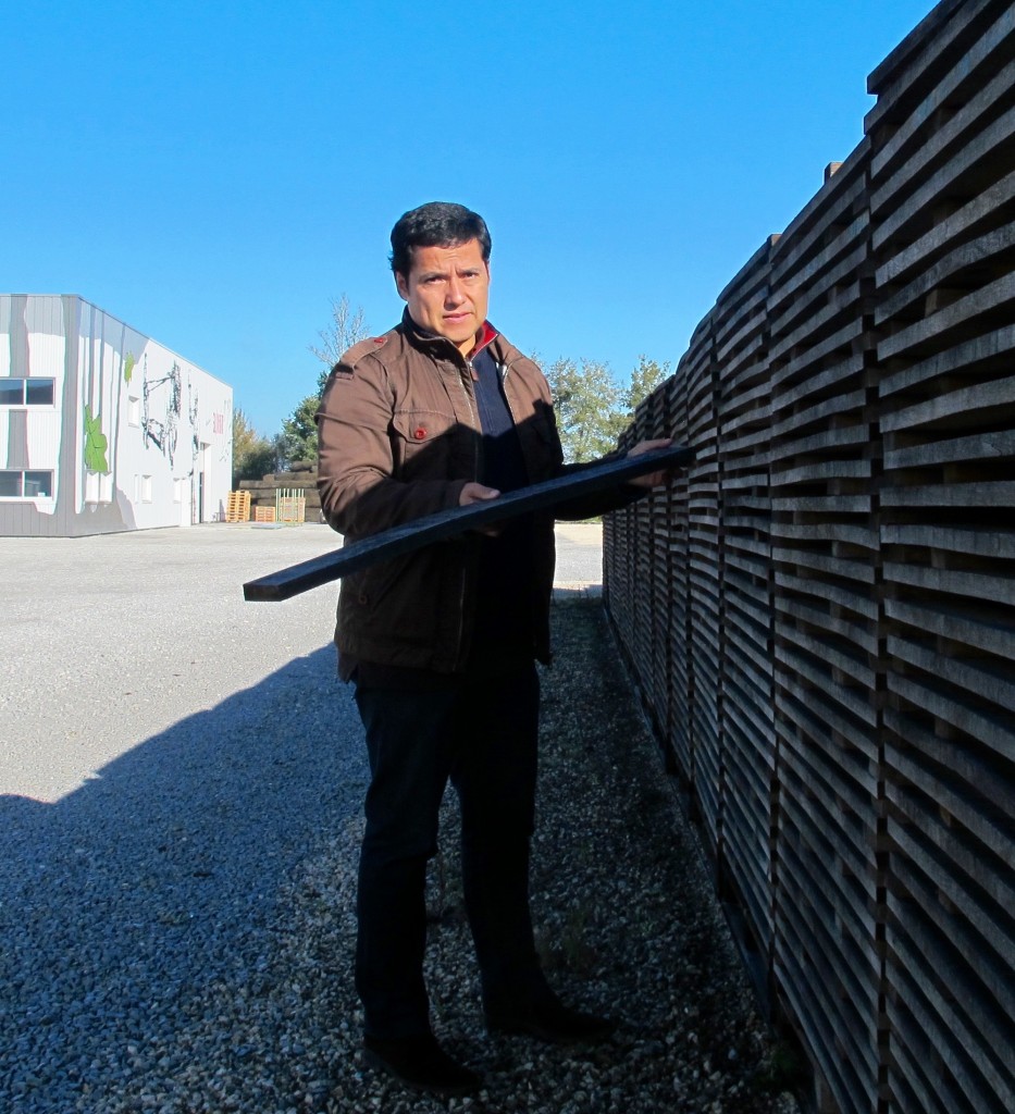 Rodrigo Luna, Export Manager for Tonnellerie Sylvain checks a plank in ond of hundreds of stacks on the company property. Photo by Marla Norman.