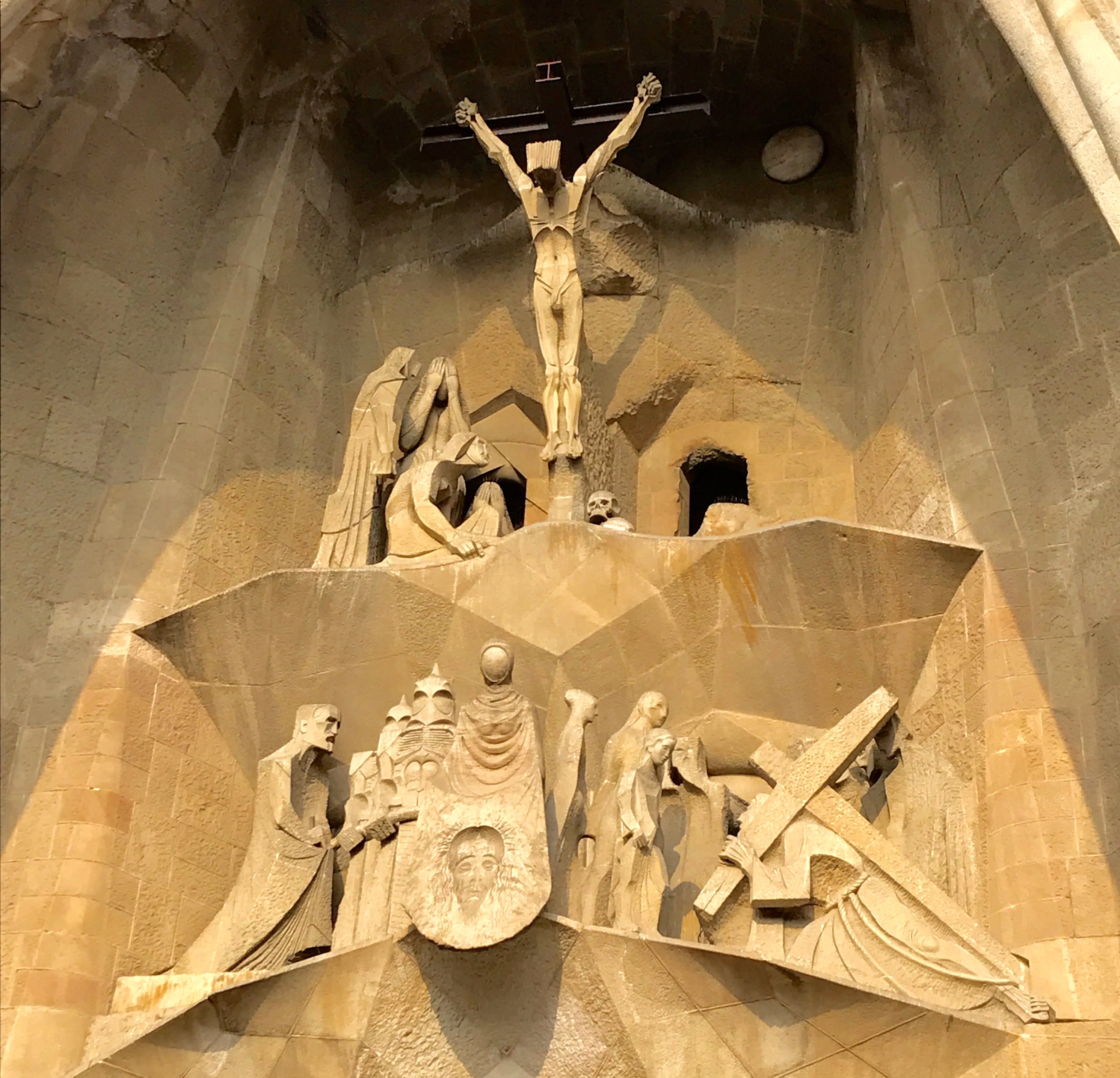 The Pasion Facade includes a haunting portrayal of the crucifixion. Gaudí himself appears in the lower left portion of the scene.
