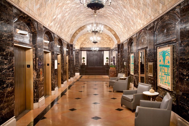 The hotel's historic past have been meticulously preserved: an ornate archway entrance, marble foyer and detailed wood moldings. Photo courtesy of the Hilton New Orleans - St. Charles Avenue.