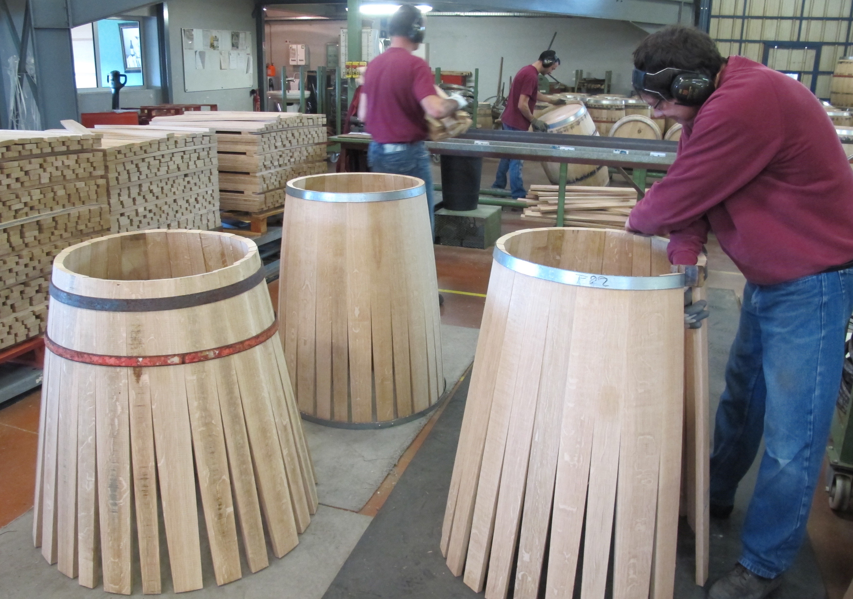Sylvain coopers expertly bend the planks within the iron stays used to assemble the barrels. Photos by Marla Norman.