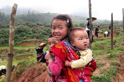 A cute Black H’mong girl and her baby sibling.
