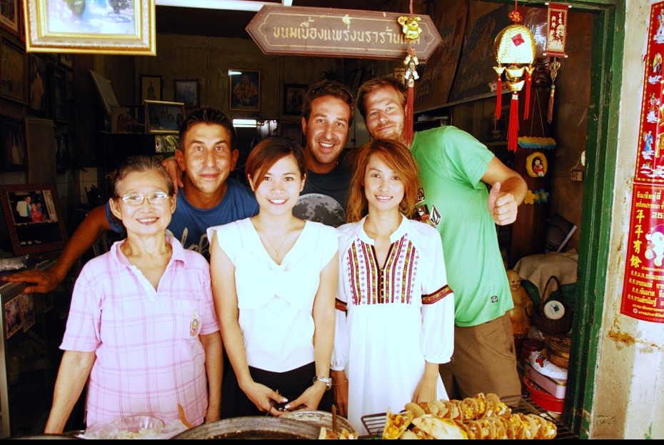 Chefs Clayton Klyne, Chad Klyne, and Lyndon Wiebe pose with three generations of cooks in their 100 year old food stall in Bangkok's old city, Sao Ching Cha. Photo courtesy of Cad Klyne. 