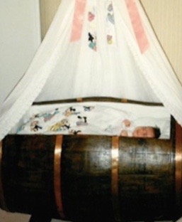 Laurie Arrivé, as a baby in her "barrique."