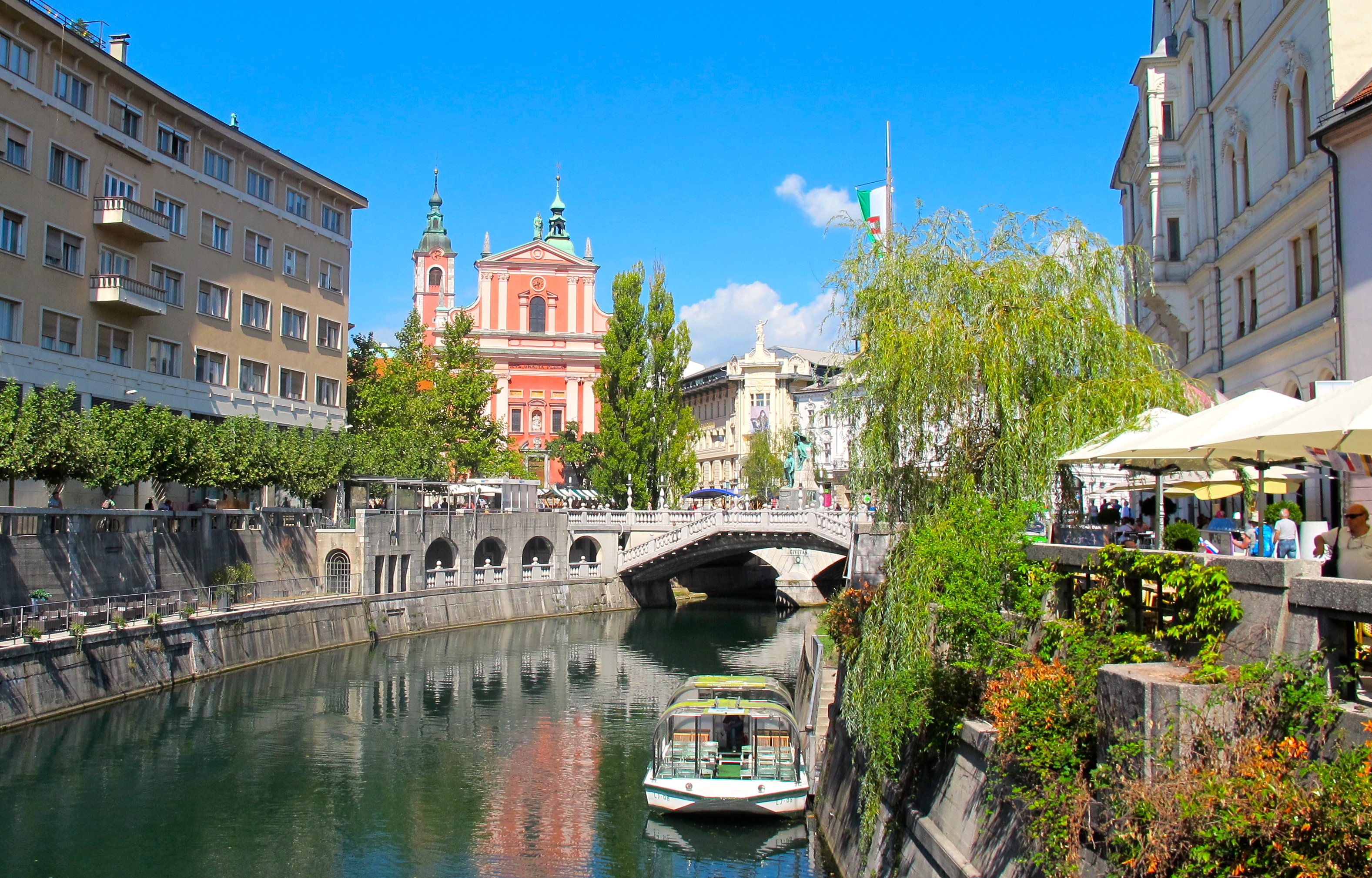 The Ljublijanica River curves and twists past lively cafes and tree-lined parks.