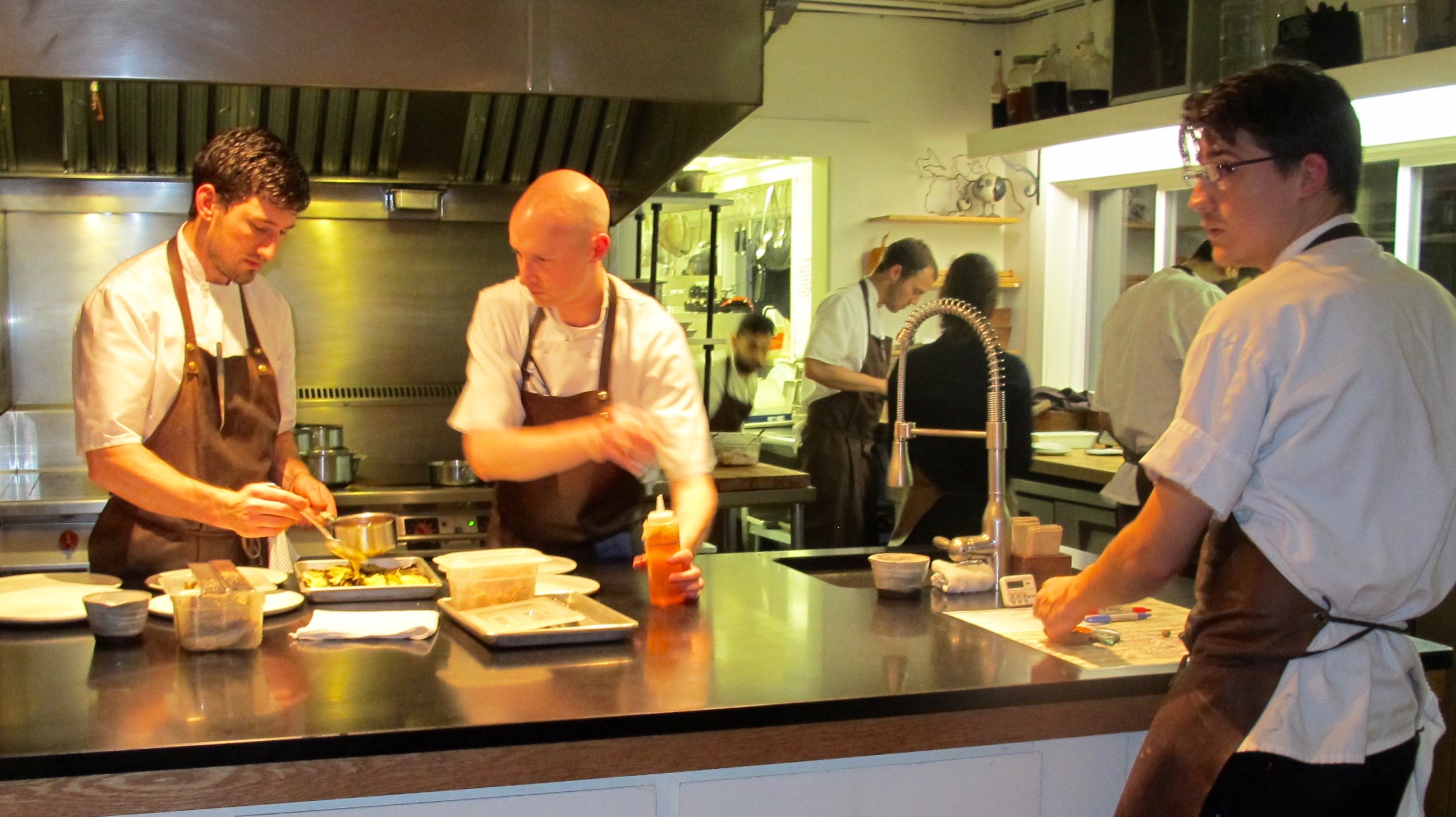 Chef Wetzel works with his crew to plate. Photo by Marla Norman.
