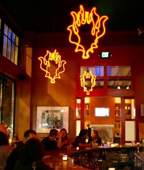Lola is poshly designed, with dark leather booths and artful neon light fixtures. 